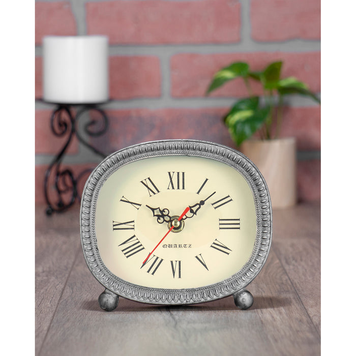 Red Co. Rustic Oval Shaped Metal Tabletop Battery Operated Roman Numeral Quartz Clock 5.75" x 5.5"